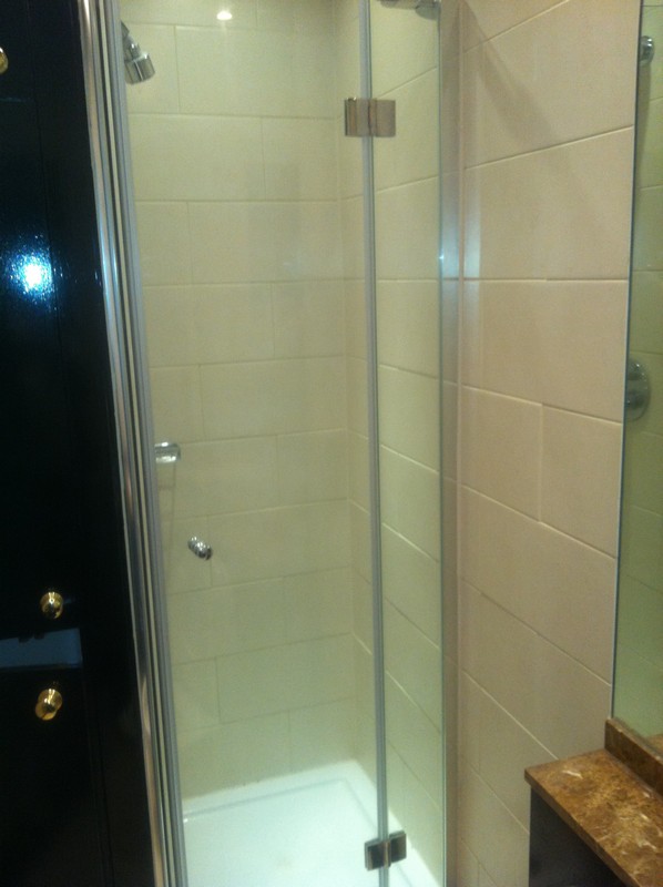 Frameless glass shower enclosure with chrome fittings in Olney