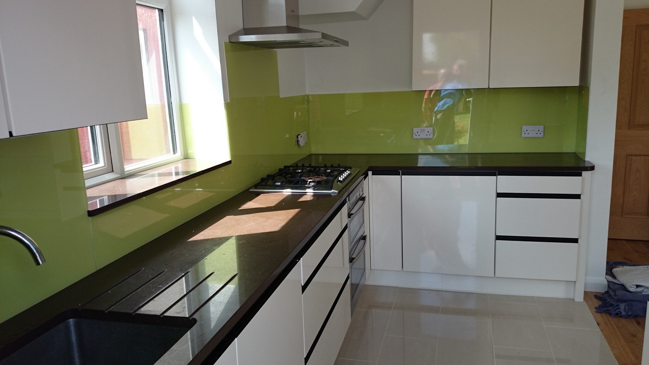 Lime green glass kitchen splashback installed by Olney glaziers