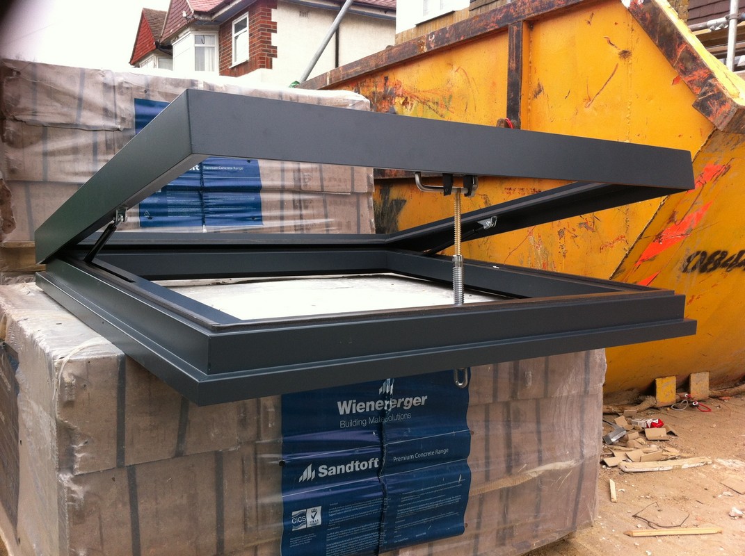 Opening flat roof skylight in anthracite grey installed in Olney
