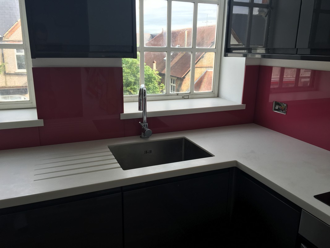 Deep plum coloured glass splashback in modern Olney kitchen